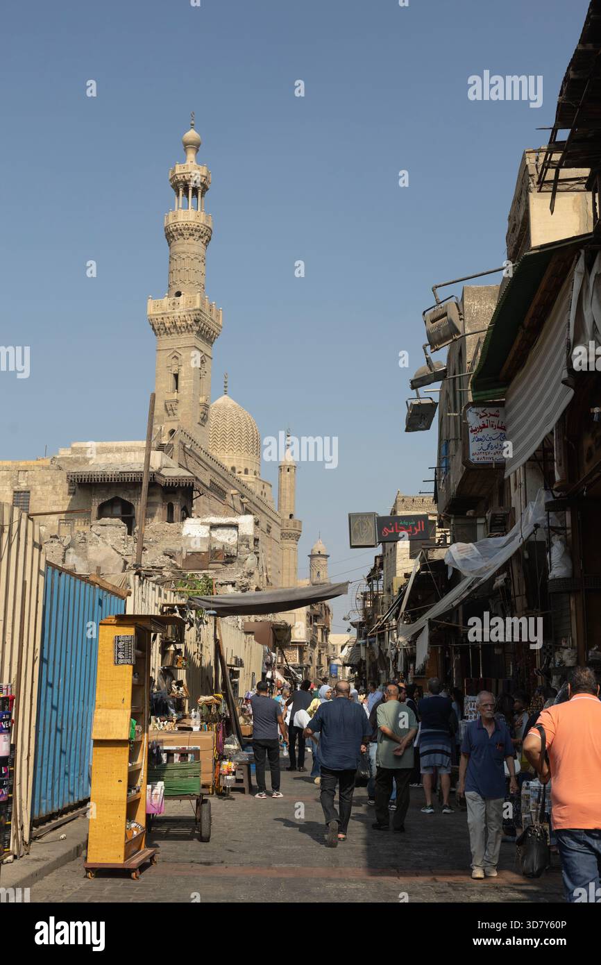 Locals and visitors mingle in the shadow of the Al-Ashrafi mosque on ...
