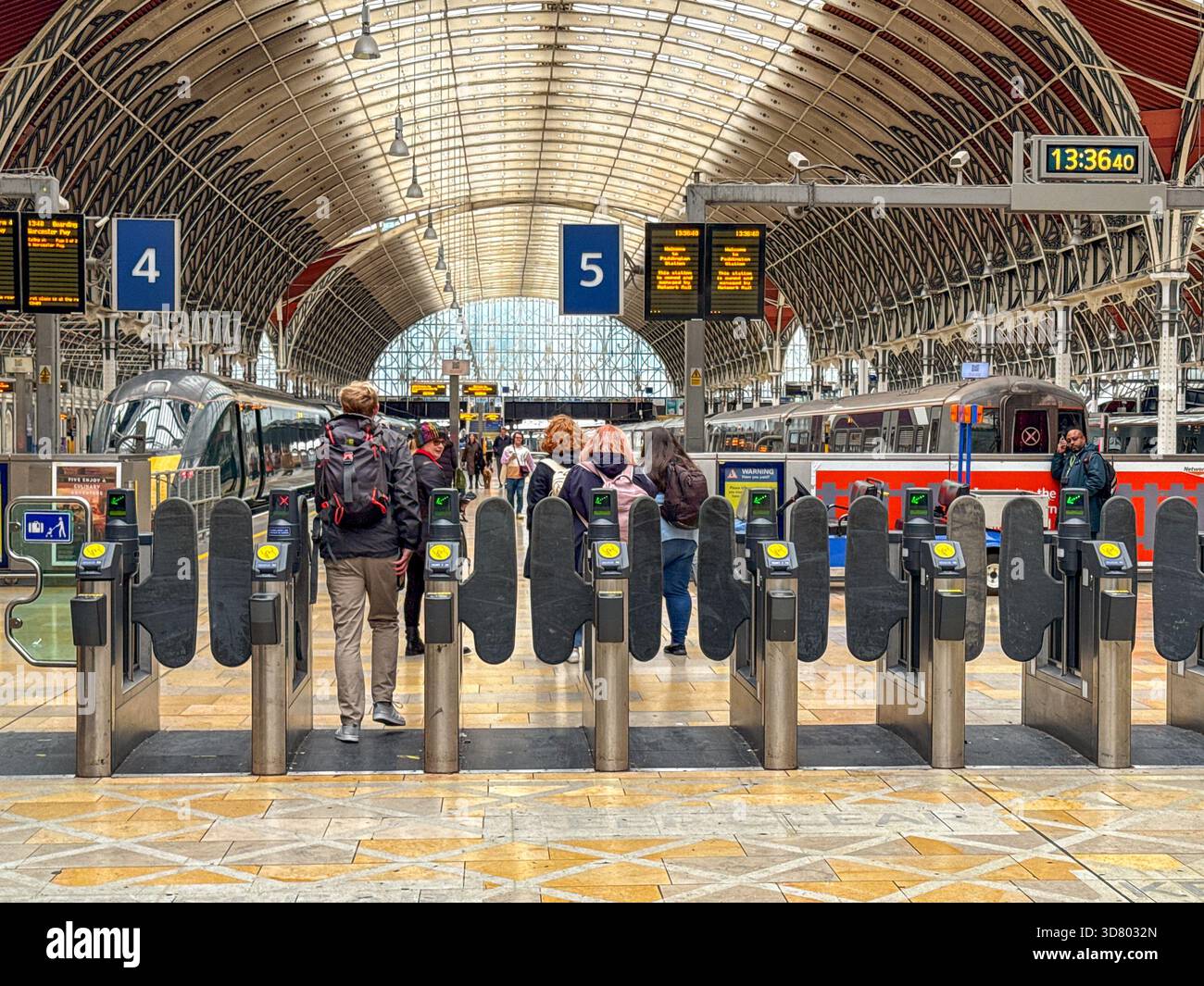 London, England, UK - 26 October 2025: People walking through ticket barriers at London Paddington railway station to catch a train. - Smartphone Captured Stock Image