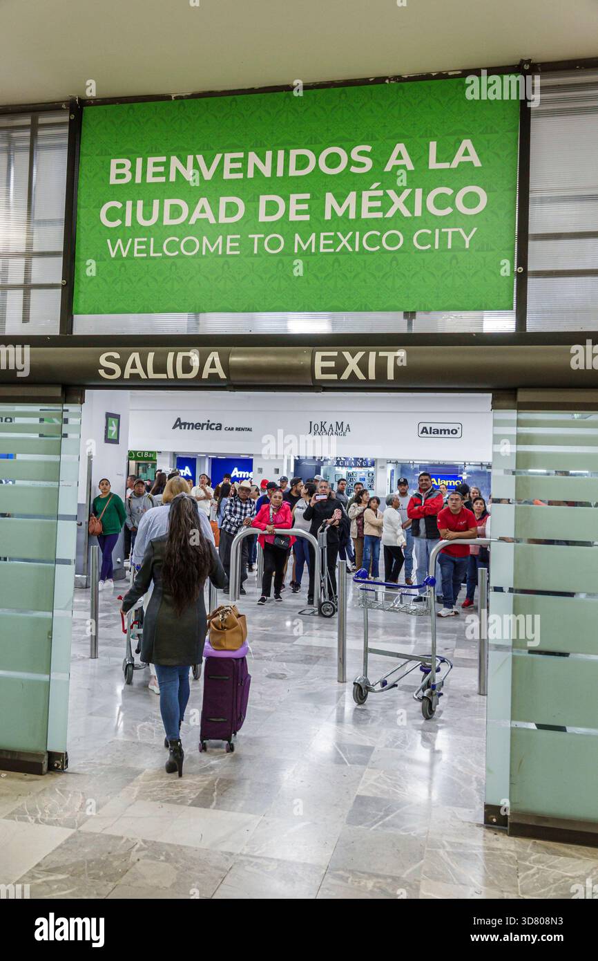 Mexico City Mexico, Benito Juarez International Airport MEX, Welcome to Mexico City bilingual sign, salida exit doors, arrival hall people waiting fam Stock Photo