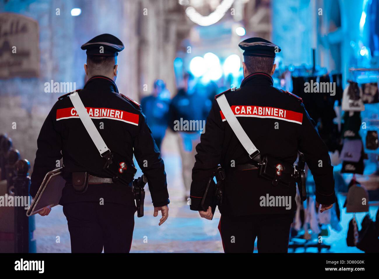 Rear view of two uniformed Italian Carabinieri police officers ...