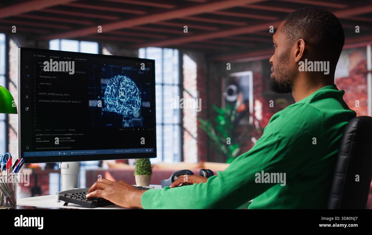 African american engineer coding a neural network AI brain model for machine learning and deep learning, solving IT support tasks on pc. Debugging software and checking for errors. Camera A. Stock Photo