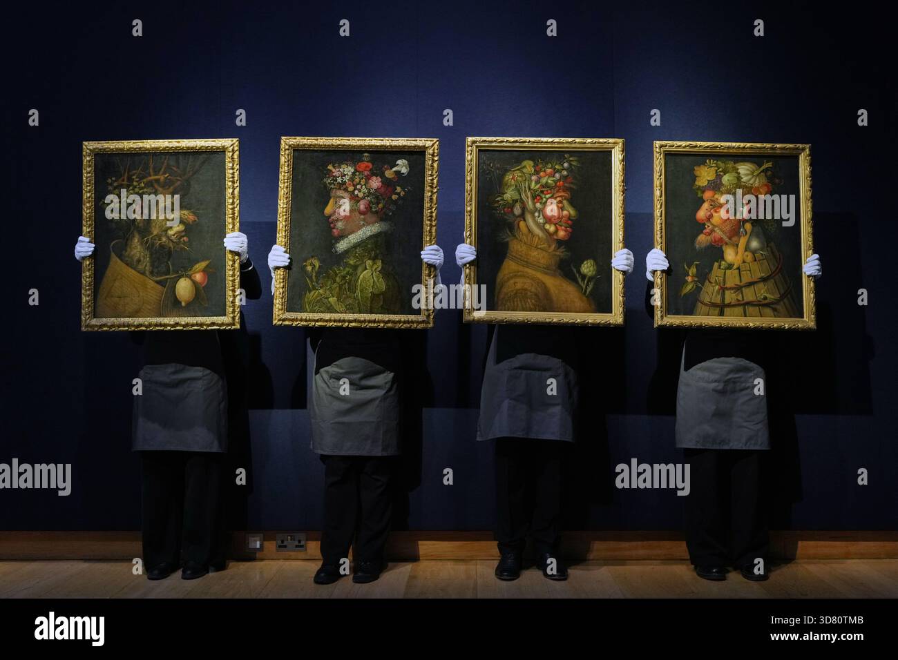 FILE - Employees hold up the Workshop of Giuseppe Arcimboldo (Milan ...