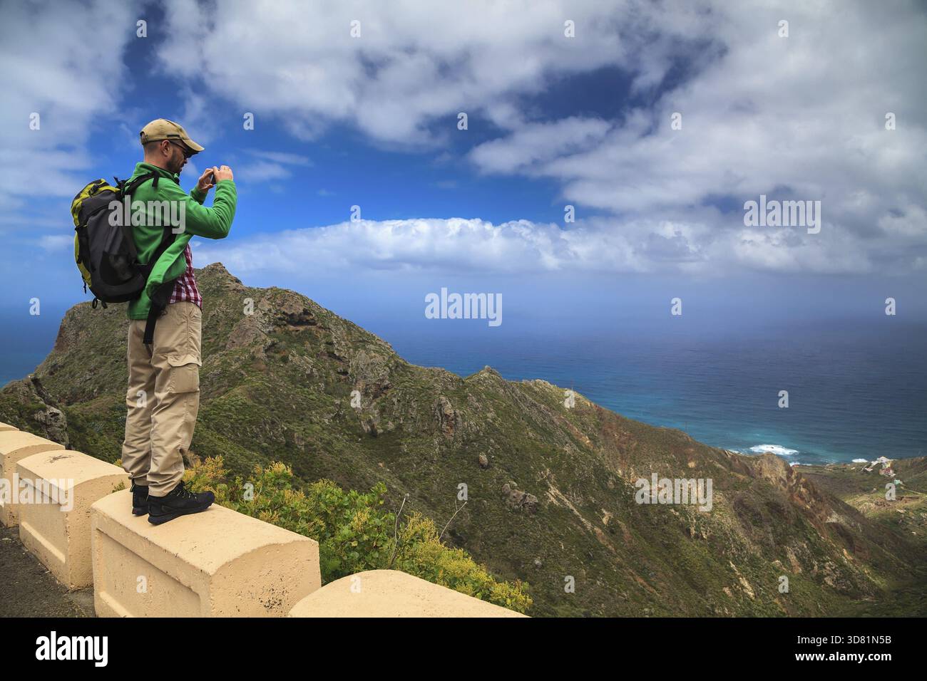 A tourist man taking the landscape photograph using his mobile smartphone Stock Photo