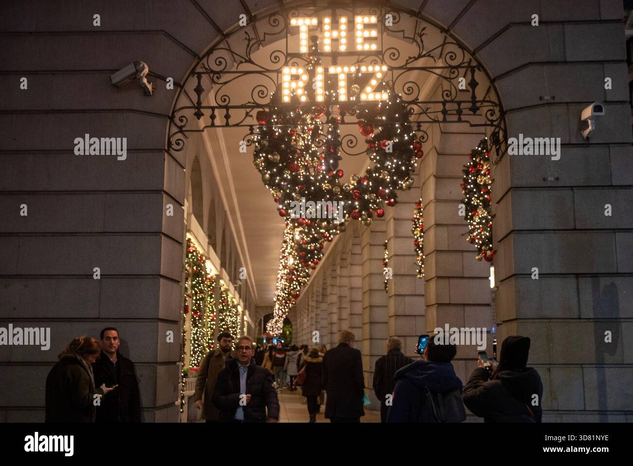 People walk on the beautifully decorated Ritz arches in London. British ...
