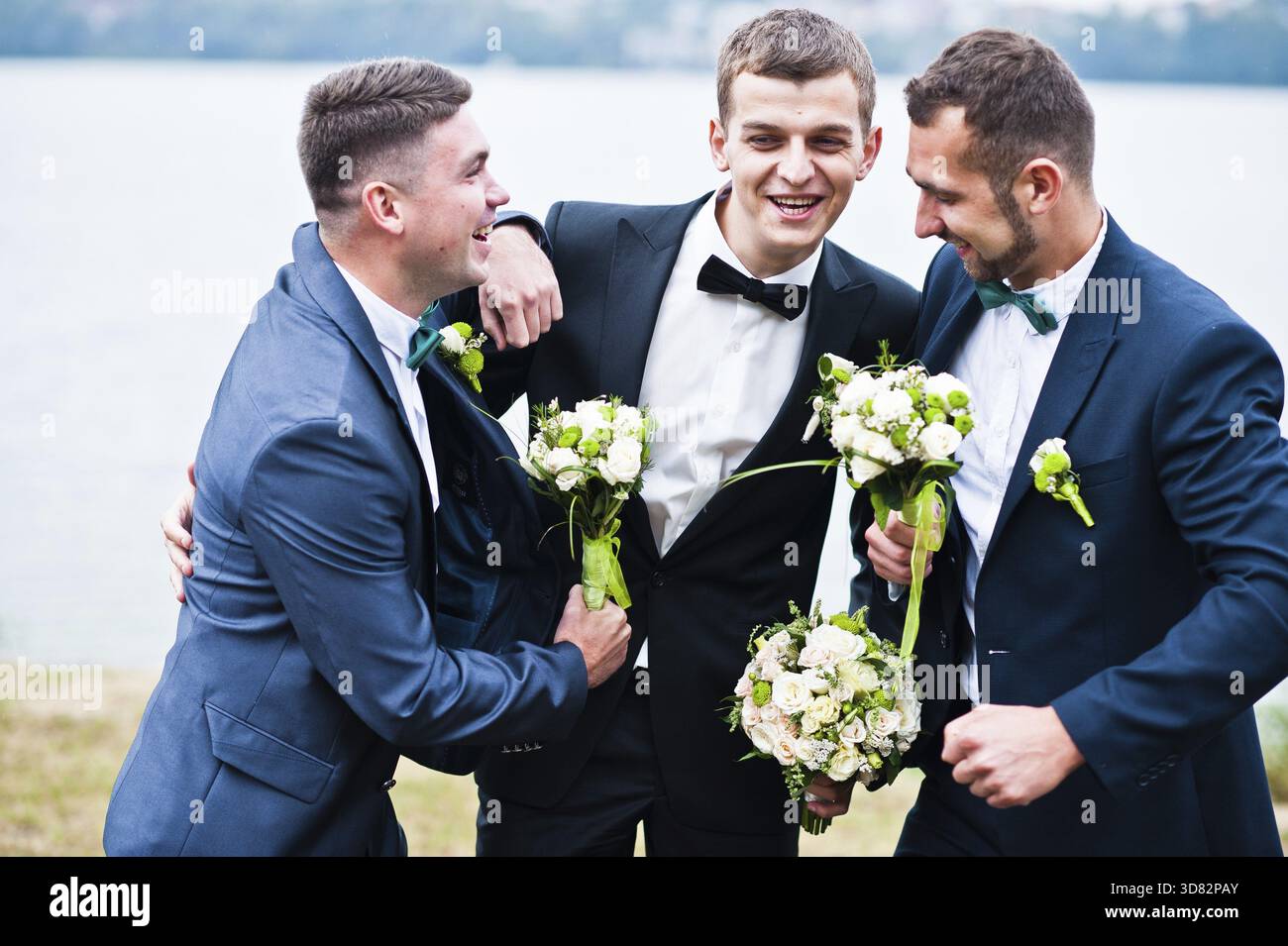 Three friends, groom with groomsman having fun Stock Photo