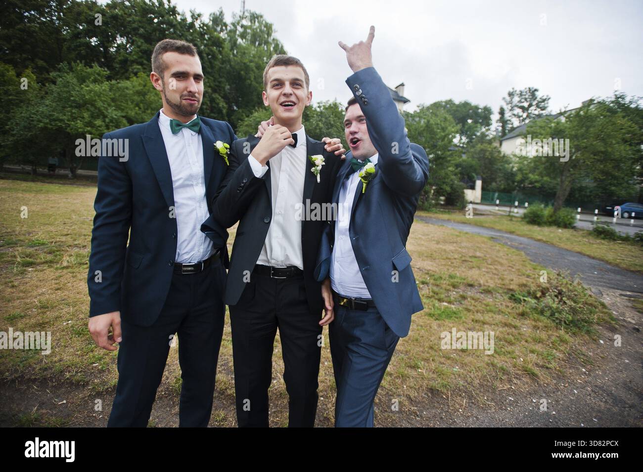 Three friends, groom with groomsman having fun Stock Photo