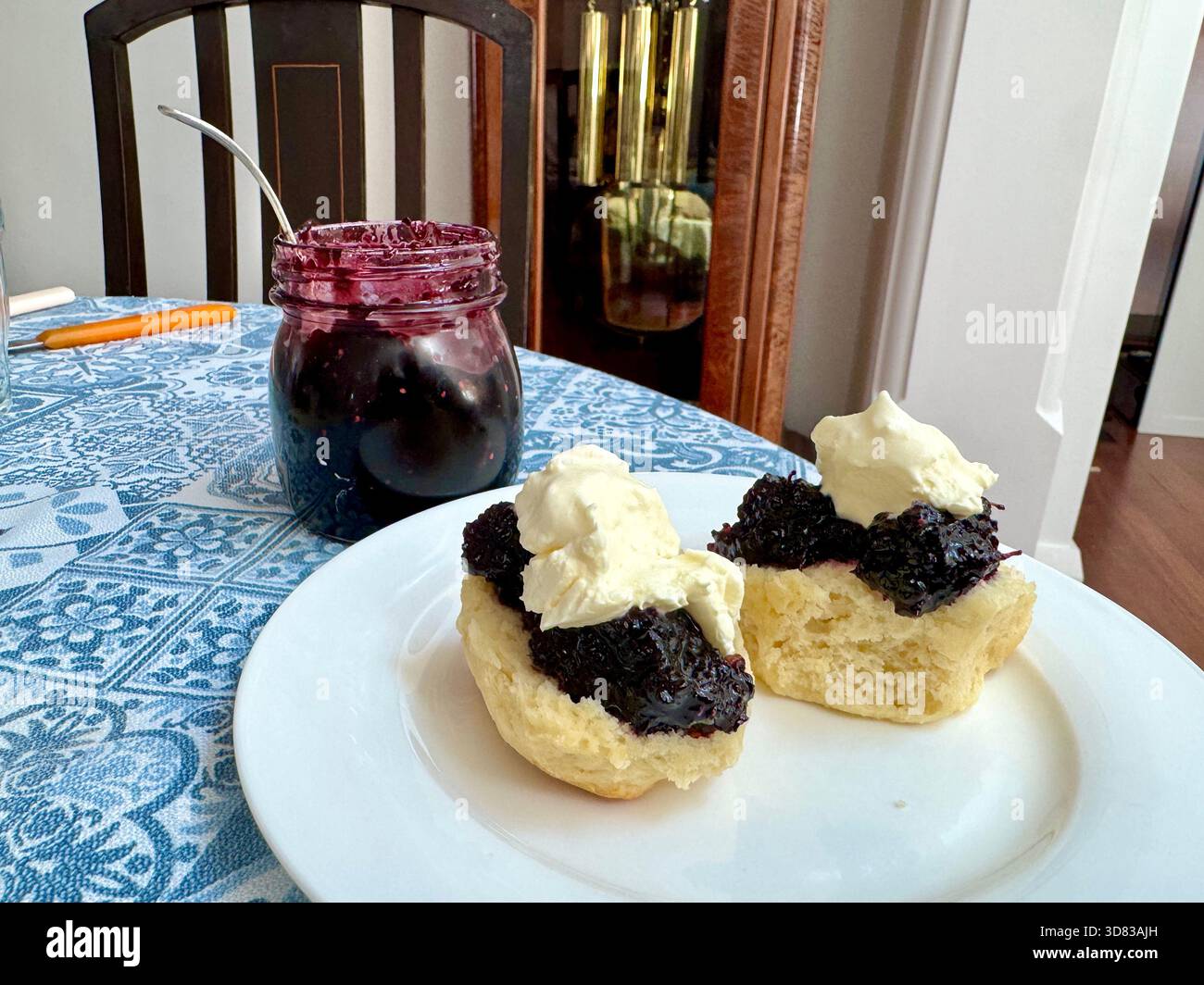 Freshly baked scone with homemade mulberry jam and cream - Smartphone Captured Stock Image