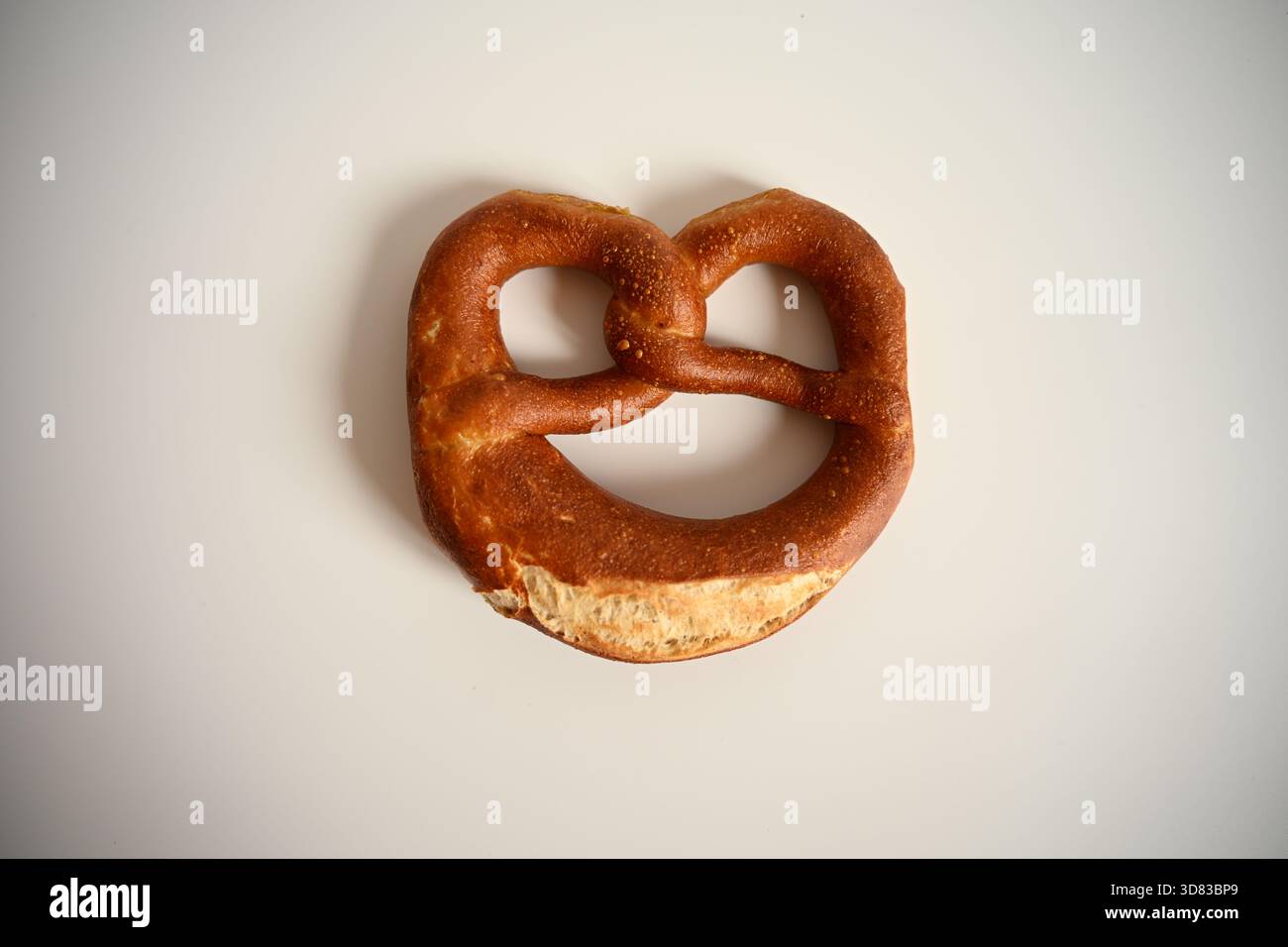 Single Traditional German Pretzel on White Background Stock Photo