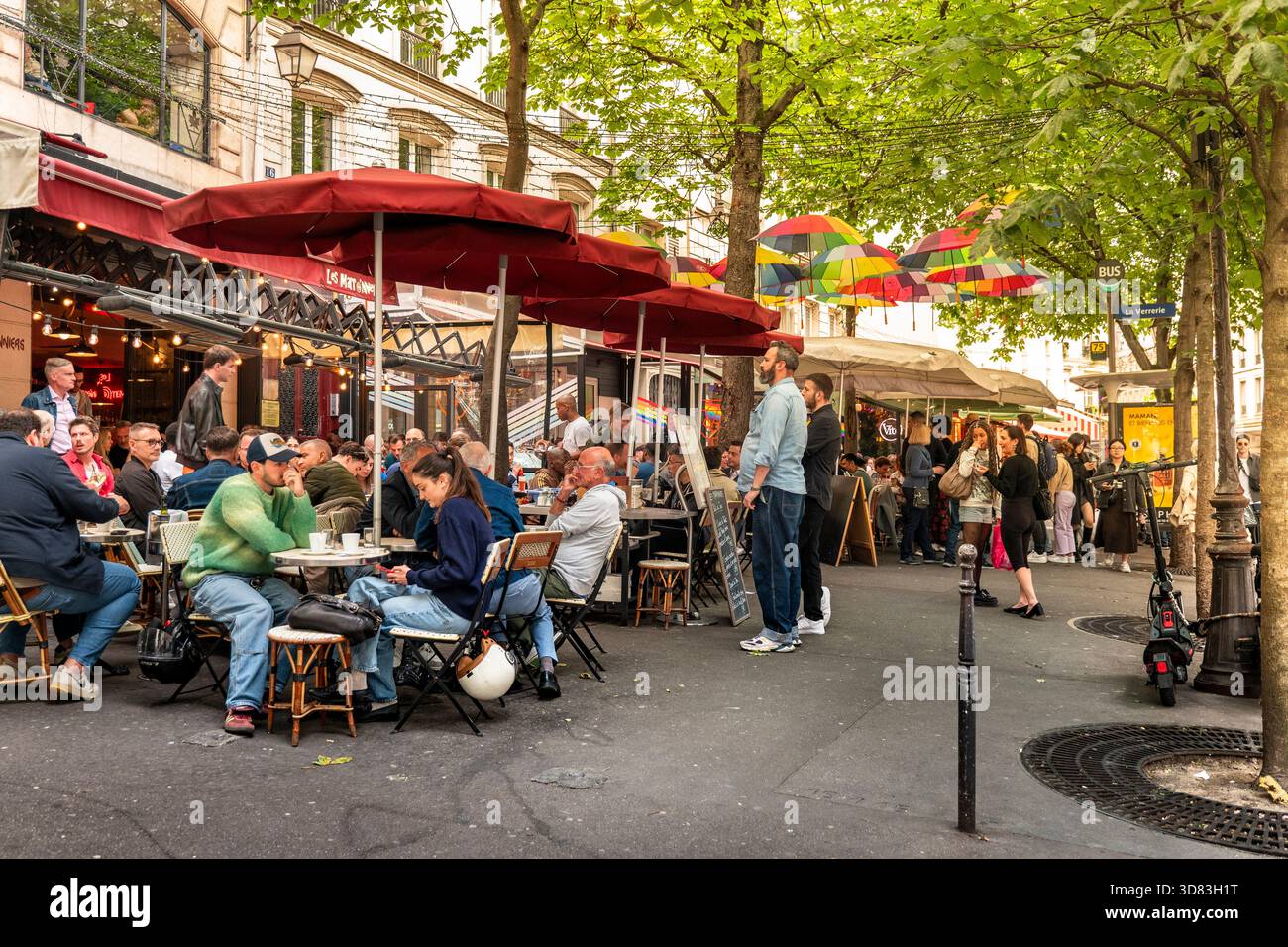 paris-france-rainbow-umbrellas-over-street-near-cafes-in-marais-stock