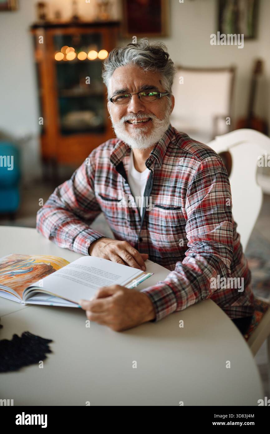 Smiling older man enjoying a quiet moment Stock Photo