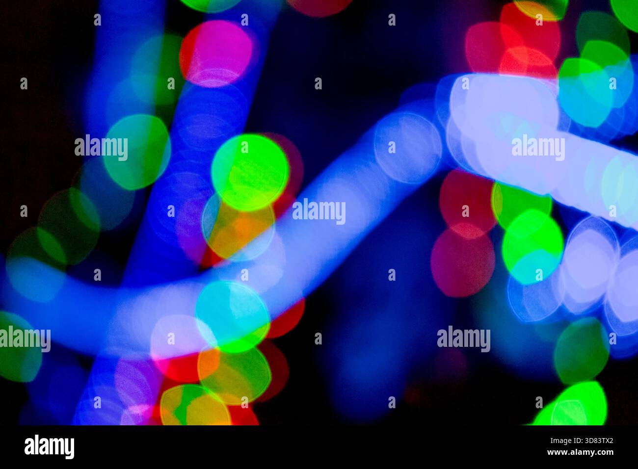 new year lights bokeh background. defocused abstract christmas decorations. blurred garland for festive mood. technological winter holidays. shimmerin Stock Photo