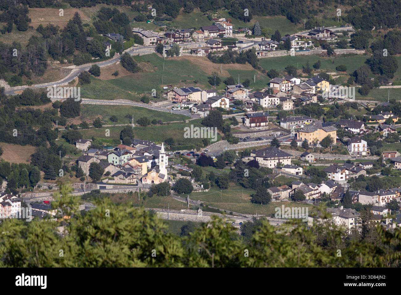 Summer aerial view of the town of Gignod, in Aosta Valley, Italy. Copy space above left. - Stock Image