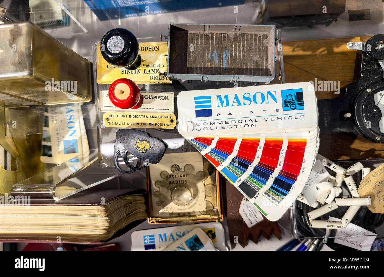 Closeup of vintage automotive and railway memorabilia & Mason Paints RAL paint reference samples swatch in cluttered display of retro objects - Smartphone Captured Stock Image