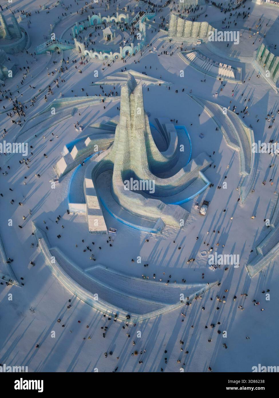 Aerial view of a gleaming ice sculpture stands tall amidst the snowy ...