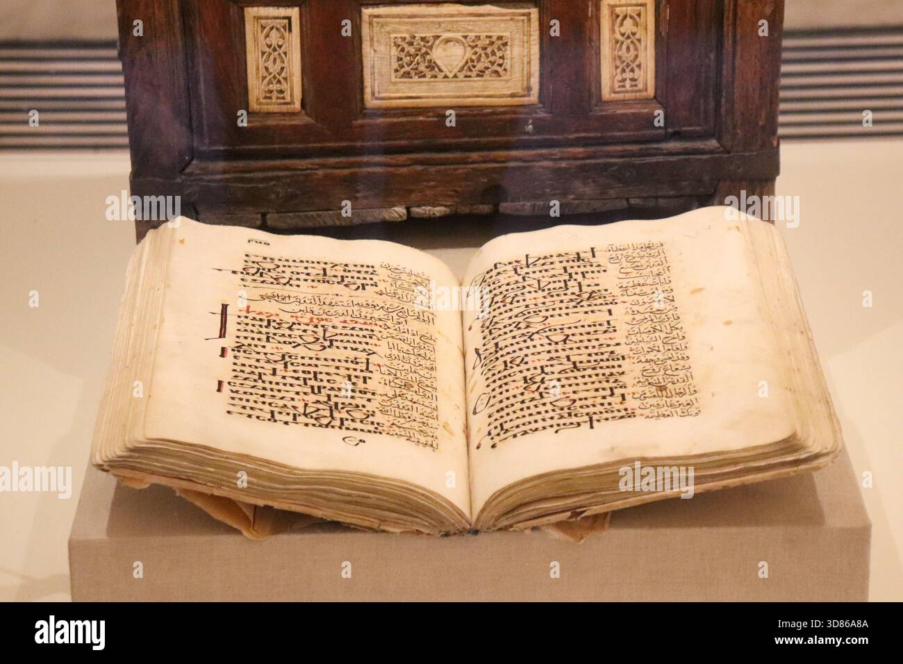 Open illuminated Coptic Bible manuscript with handwritten script on ...