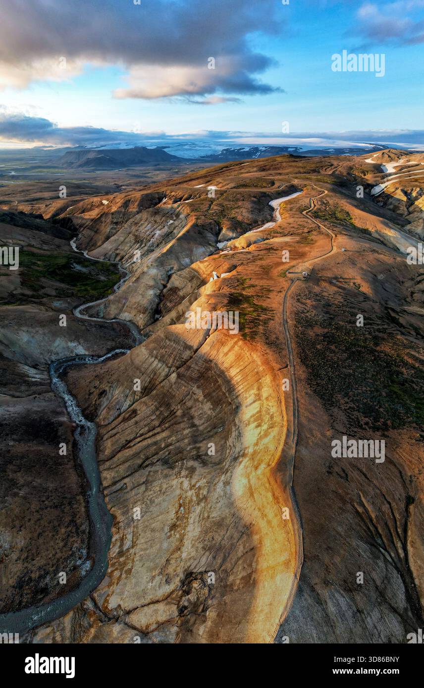 Aerial view of winding river carves through the rugged landscape ...