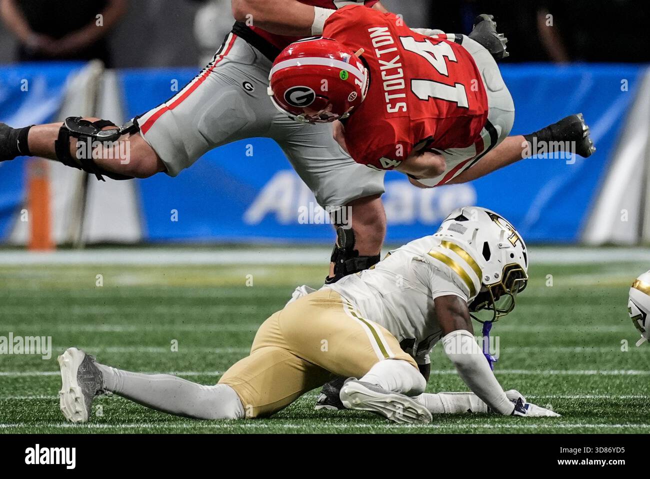 Georgia quarterback Gunner Stockton (14) falls after a hit by Georgia ...