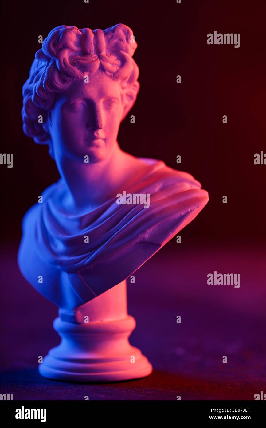 Antique Sculpture Head in Moody Neon Gradient Light Composition Stock Photo