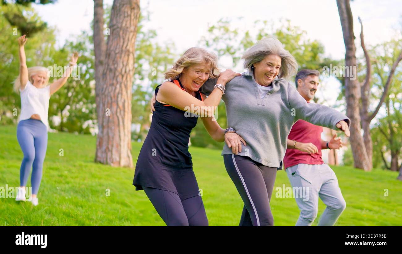Senior women laughing and running together in a park Stock Photo - Alamy