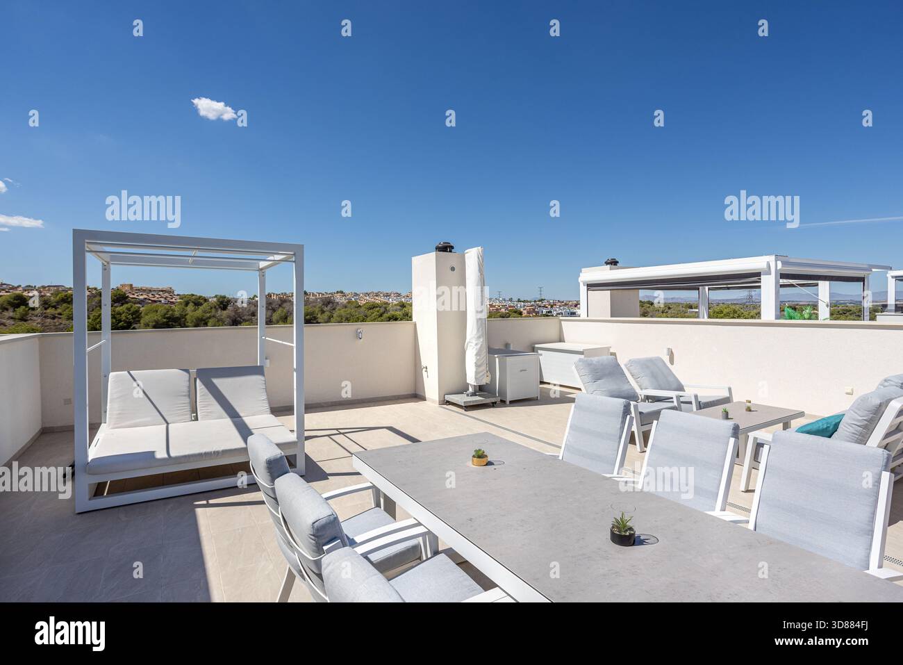 Spacious Rooftop Spacious rooftop terrace with daybed, loungers, and dining table at ...