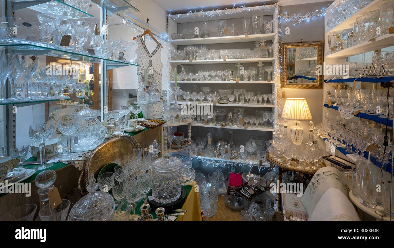 Antique glass ware for sale in an antique shop, Hay-on-Wye, Powys, Wales, UK Stock Photo