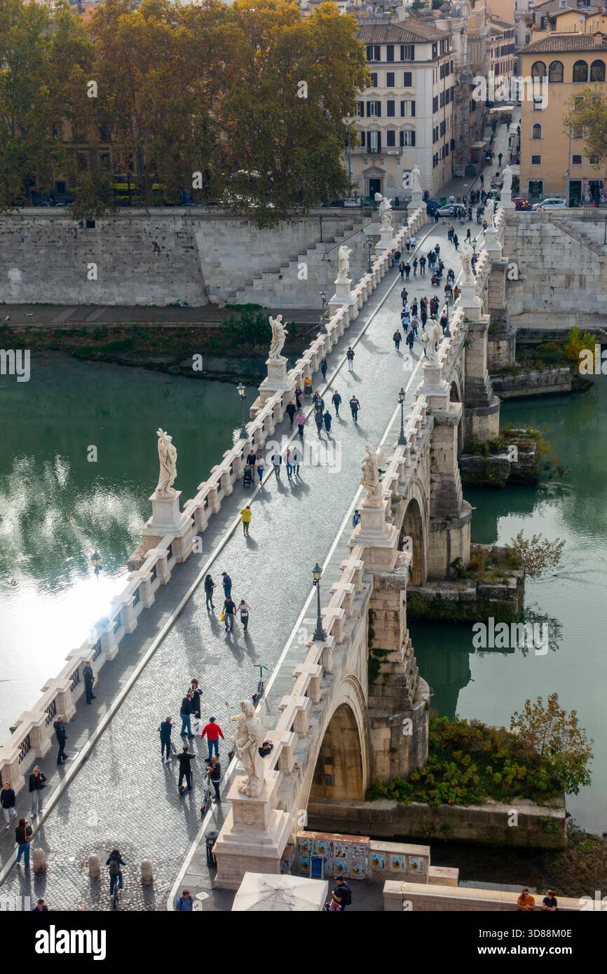 People are walking across the Ponte Sant'Angelo, a historic bridge in ...