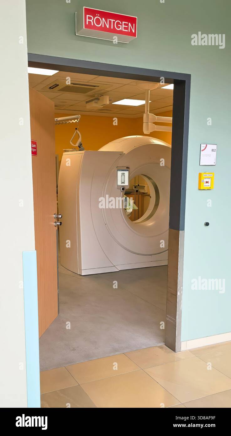 Berlin, Germany - June 16, 2025: Medical imaging room features a CT scanner and Rontgen sign above the doorway. - Smartphone Captured Stock Image