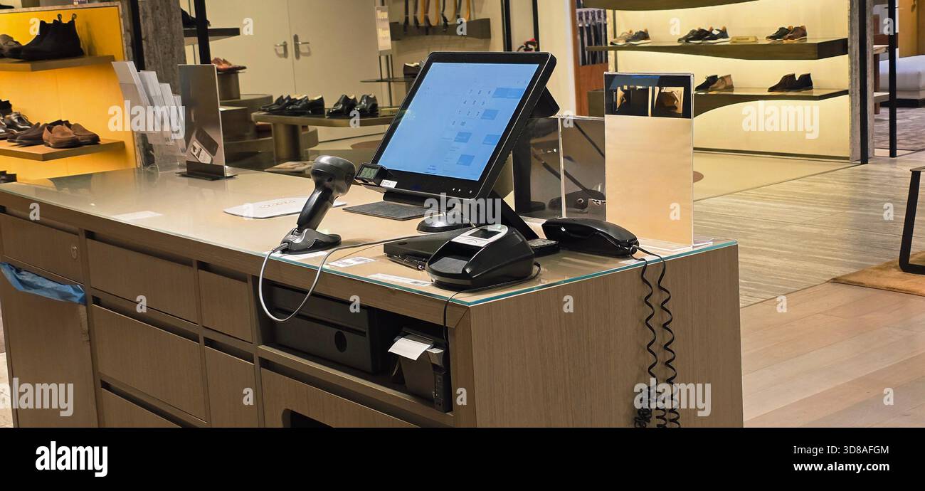 Berlin, Germany - September 19, 2025: Retail checkout area features modern technology and stylish shoe display in background. - Smartphone Captured Stock Image