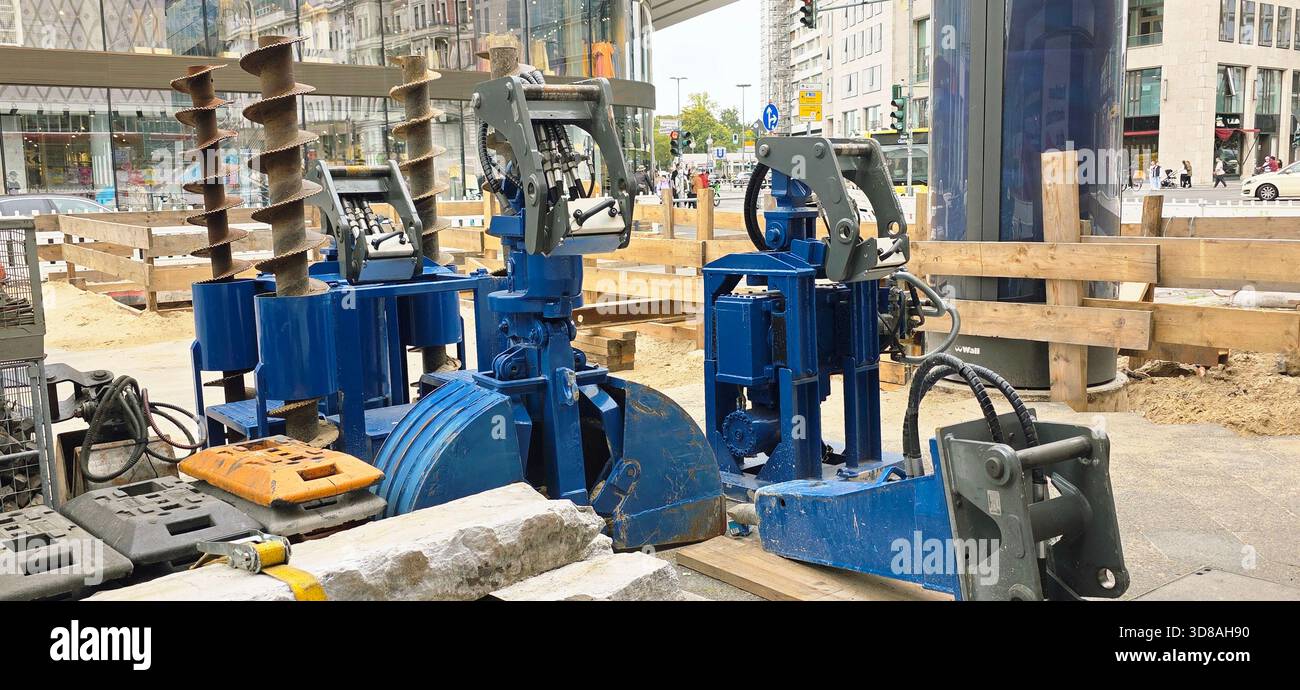 Berlin, Germany - September 22, 2025: Construction site features blue hydraulic machinery and tools in urban environment. - Smartphone Captured Stock Image