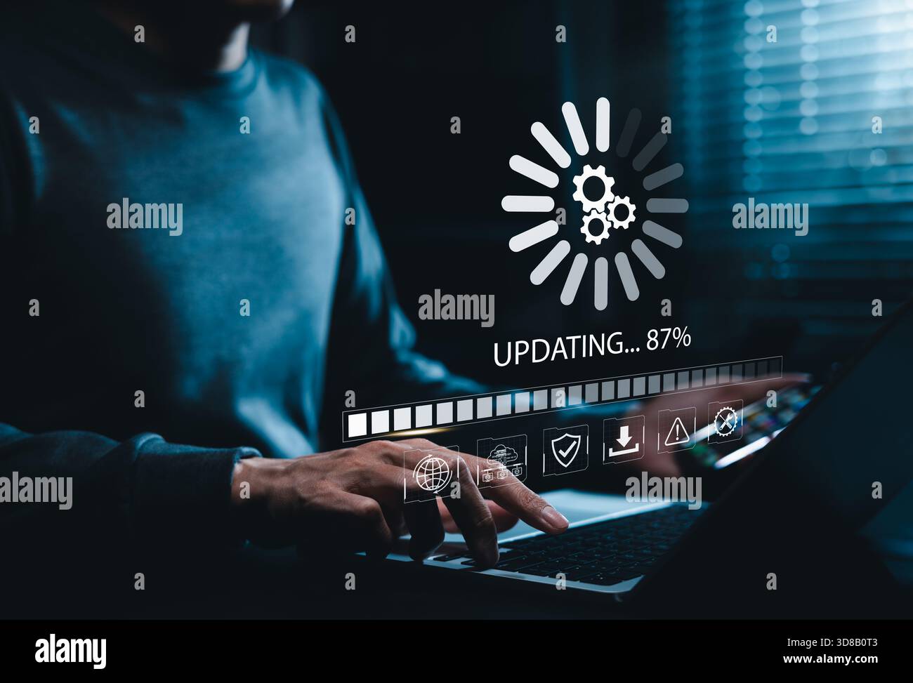 Software Update and System Upgrade Concept. Person holding phone while using laptop with software update progress interface and security, technology m Stock Photo