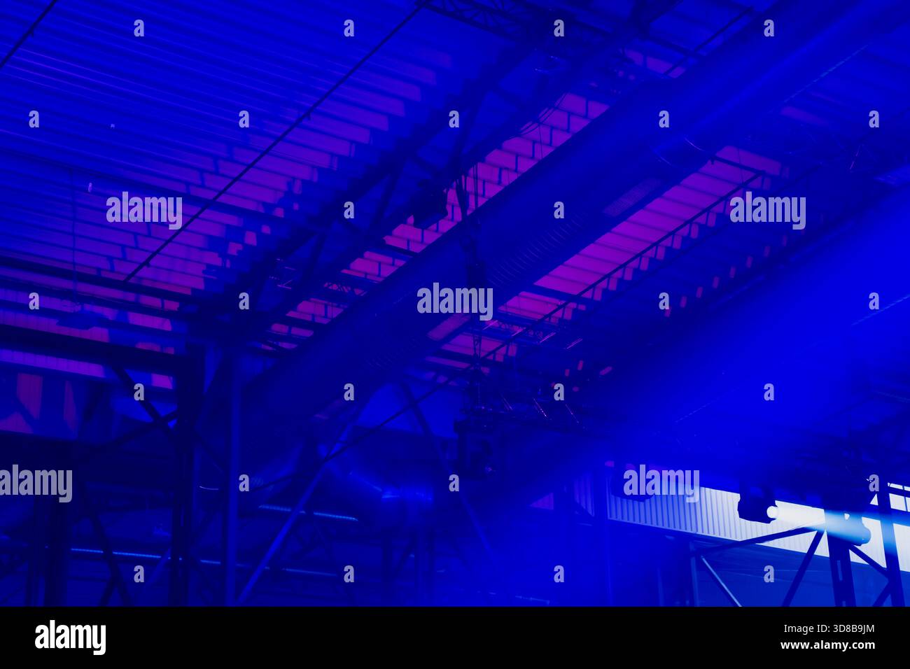 Industrial event hall ceiling with HVAC ducts, truss structures and ...