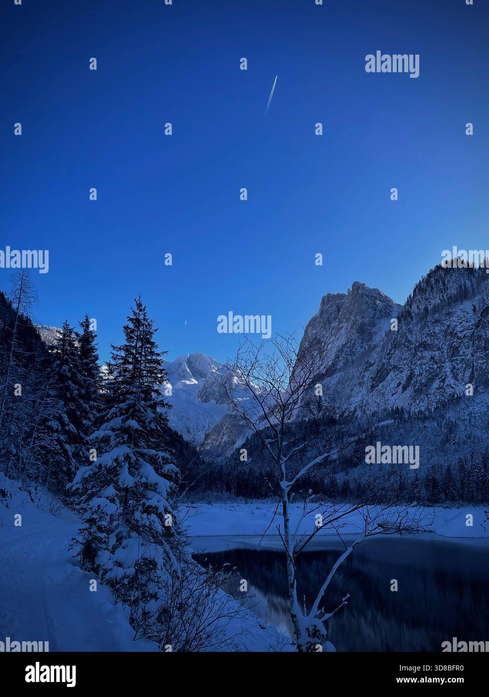 Alpine lake surroundedby snow-covered mountains - Smartphone Captured Stock Image