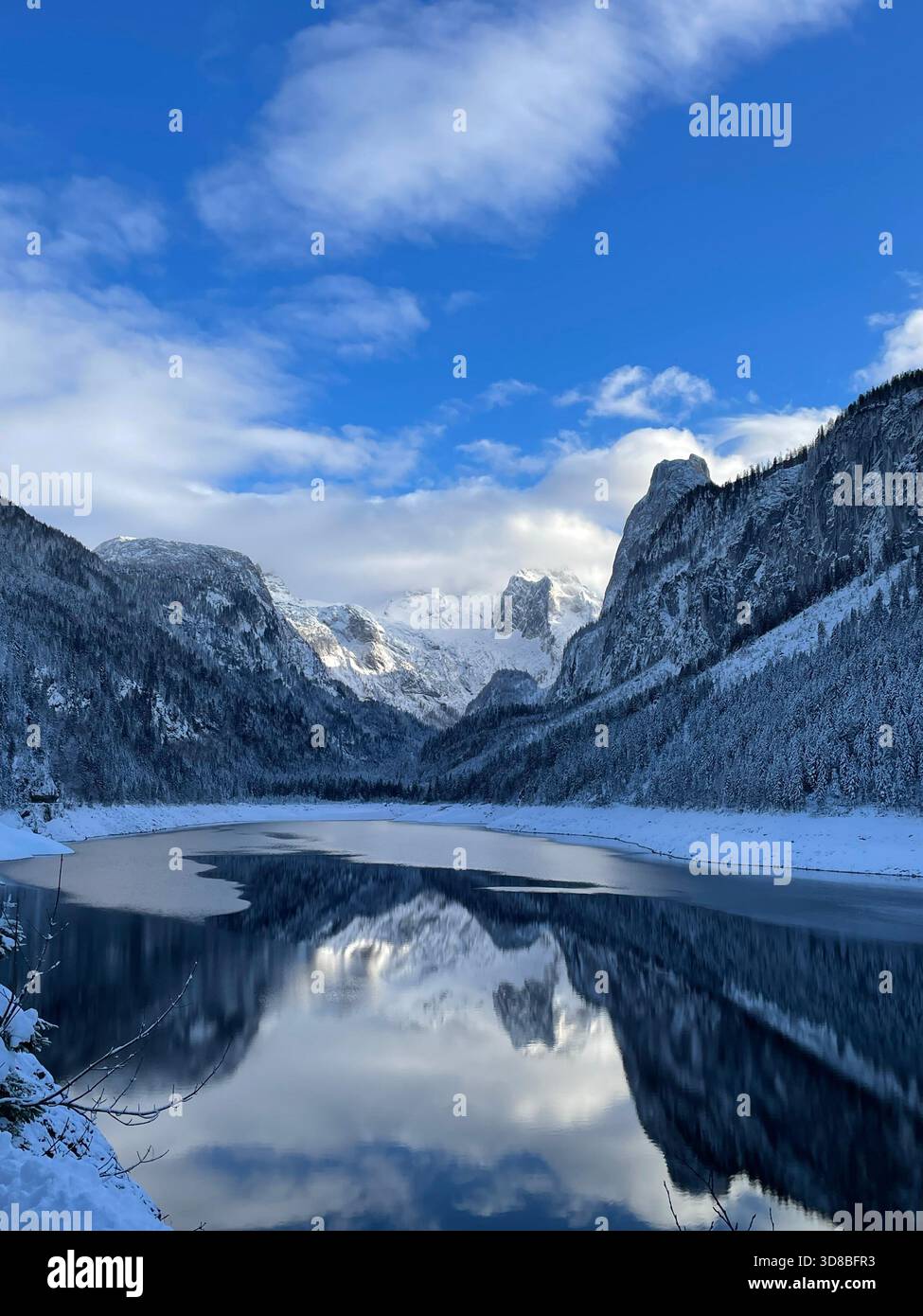 Snowy mountains reflected in a calm winter lake - Smartphone Captured Stock Image