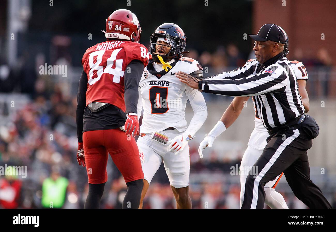 PULLMAN, WA - NOVEMBER 29: A referee rushes to break up Washington ...