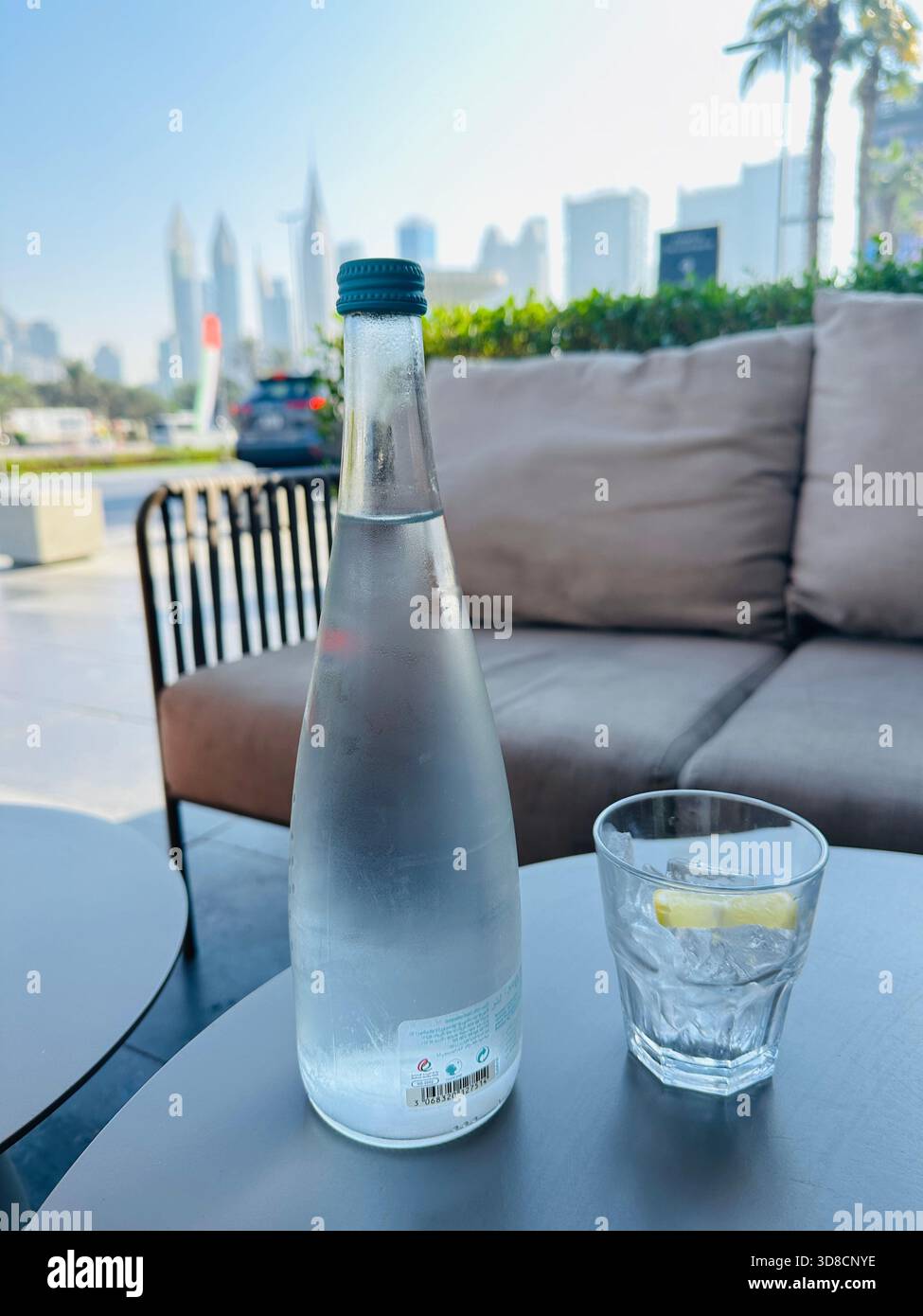 Drinking water bottle and glass cafe outside - Smartphone Captured Stock Image