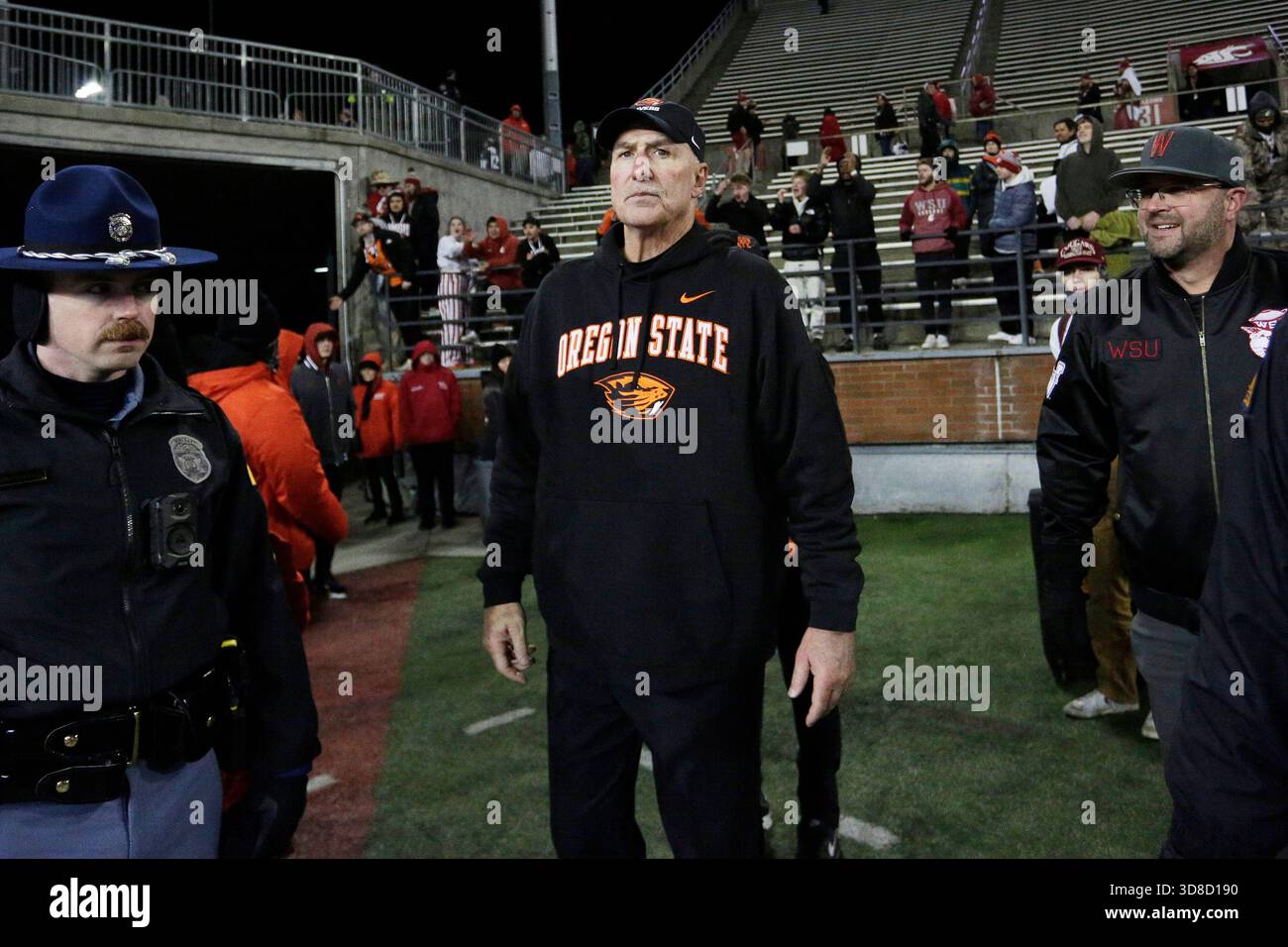 Oregon State interim head coach Robb Akey, center, stands on the field ...