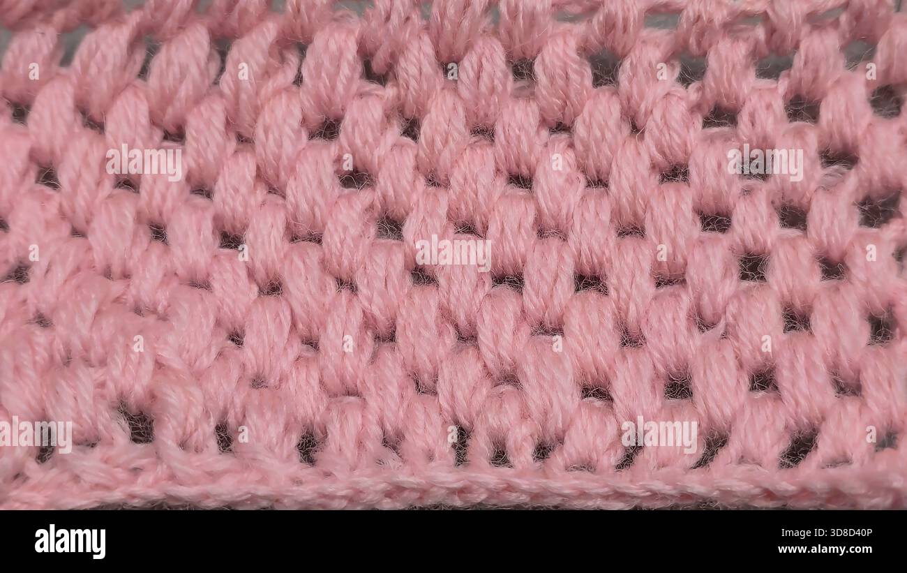Knitting patterns for sweaters, hats, and other items using light-colored yarn on a light background. Copy space. Stock Photo