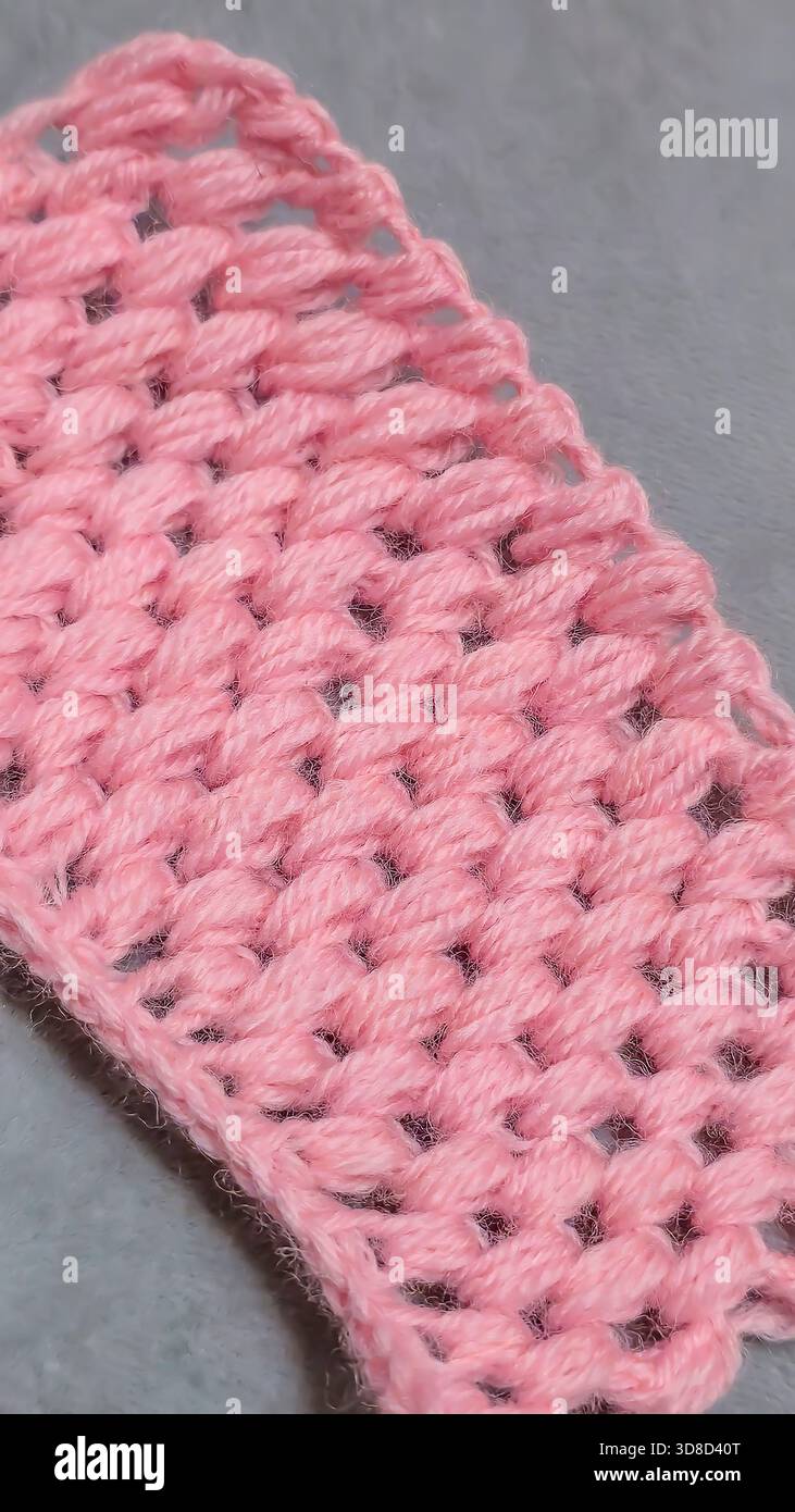 Knitting patterns for sweaters, hats, and other items using light-colored yarn on a light background. Copy space. Stock Photo