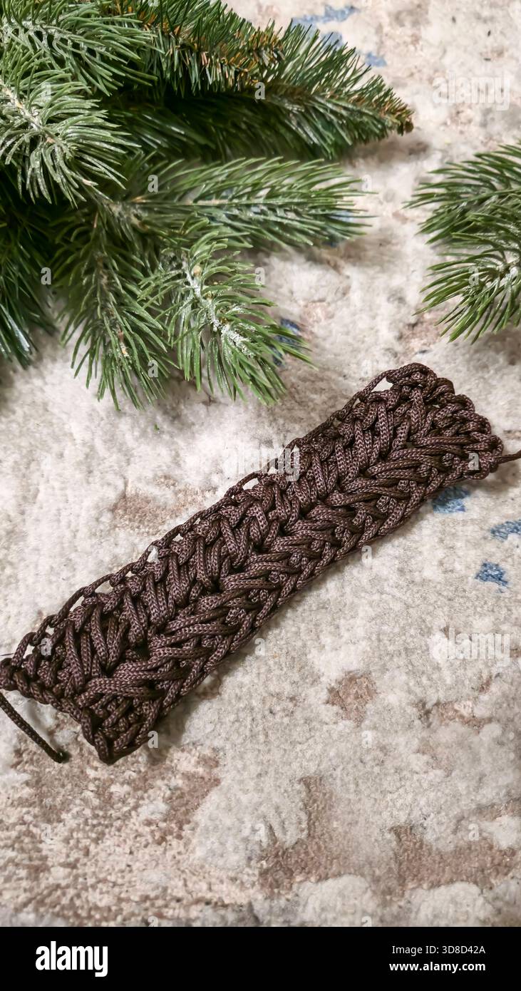 Knitting patterns for sweaters, hats, and other items using light-colored yarn on a light background. Copy space. Stock Photo