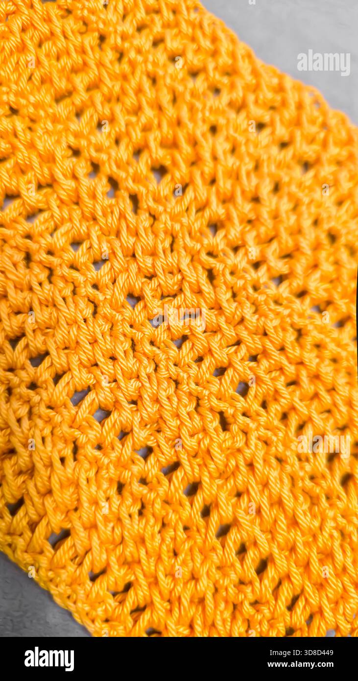 Knitting patterns for sweaters, hats, and other items using light-colored yarn on a light background. Copy space. Stock Photo
