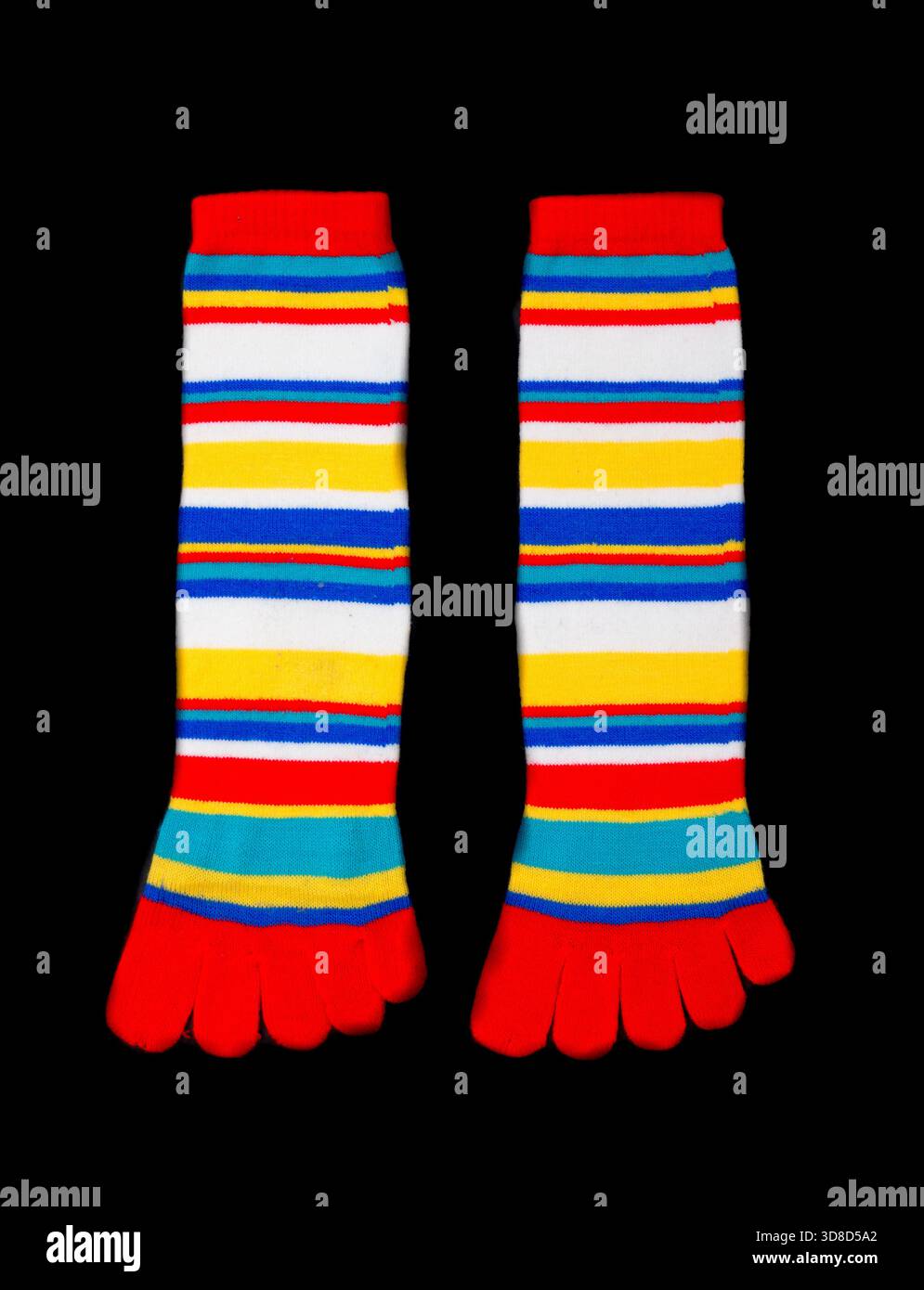 Multicolored socks on a black background. Stock Photo