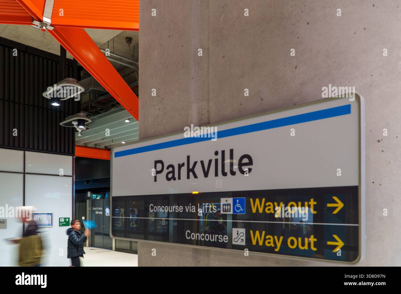 Melbourne, VIC, Australia. November 30, 2025. - A white and blue Parkville Station sign provides directions for concourse and exits in a newly opened, Stock Photo