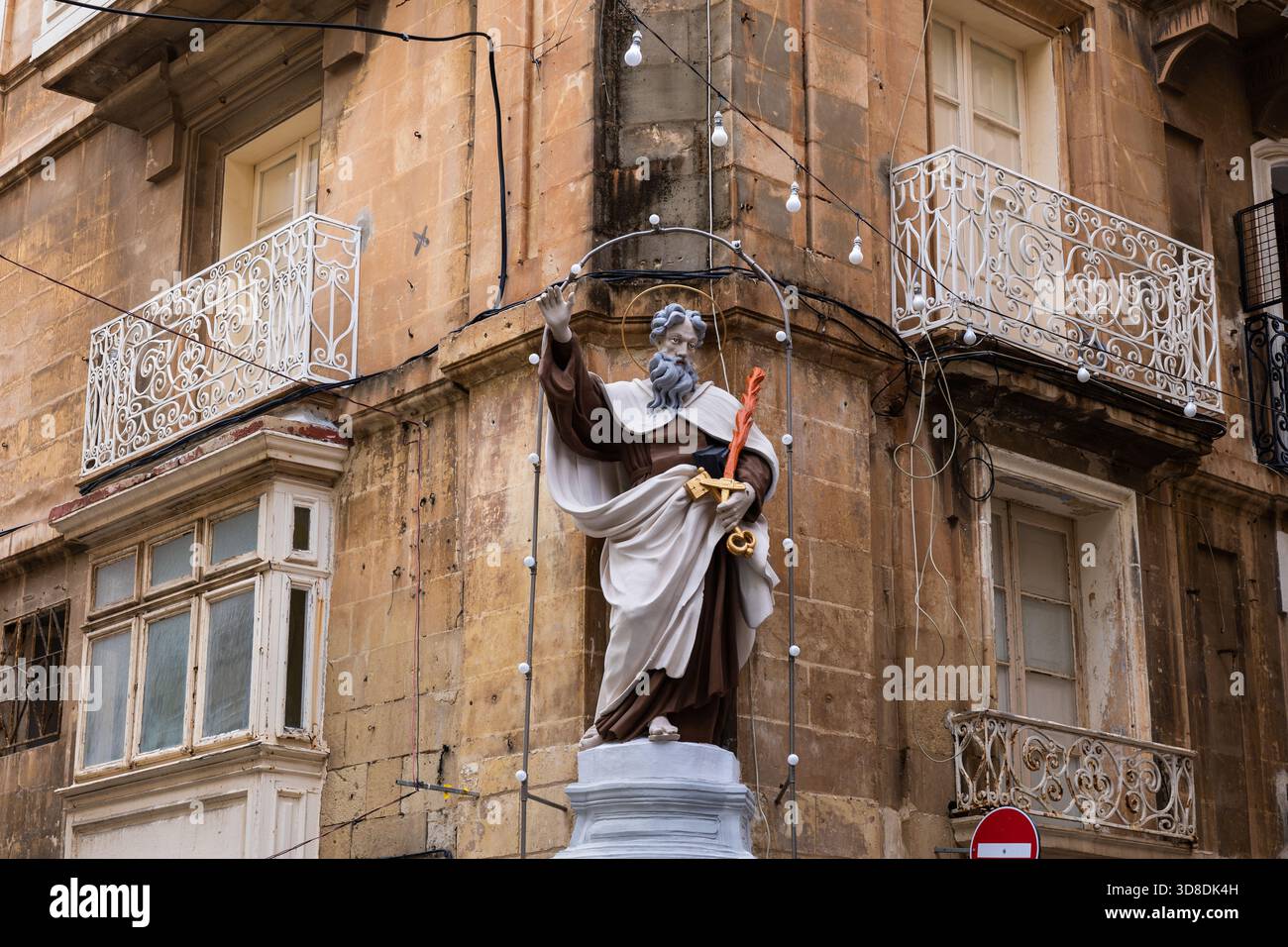 Saint Elias with fiery sword statue on building corner in city of Valletta in Malta. Stock Photo