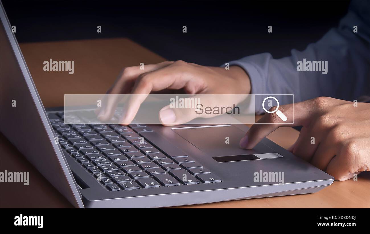 Technology Search Engine Optimization. man's hands are using a computer notebook to Searching for information. Stock Photo