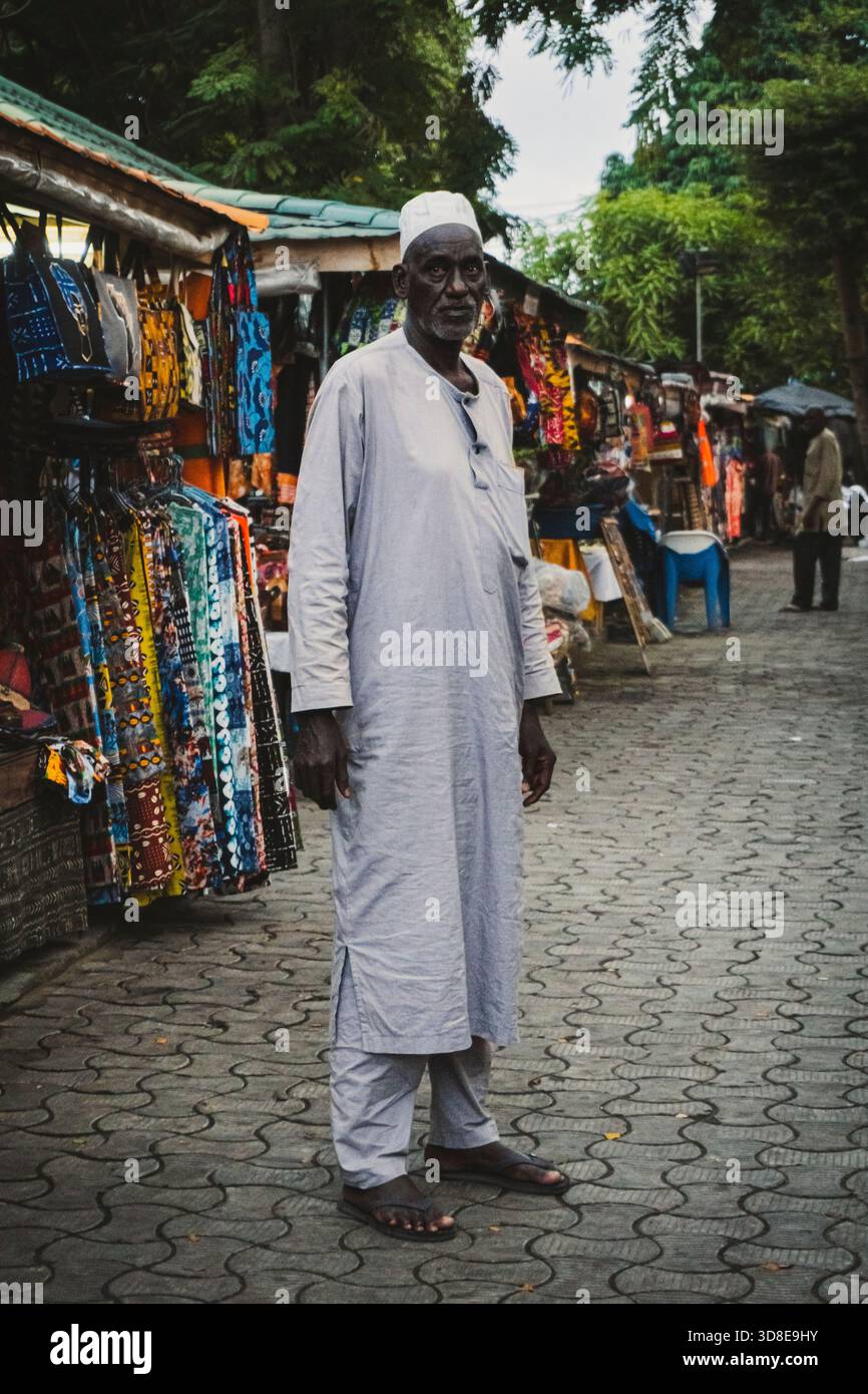 Salesman person selling african traditional clothes in Abidjan markets Stock Photo