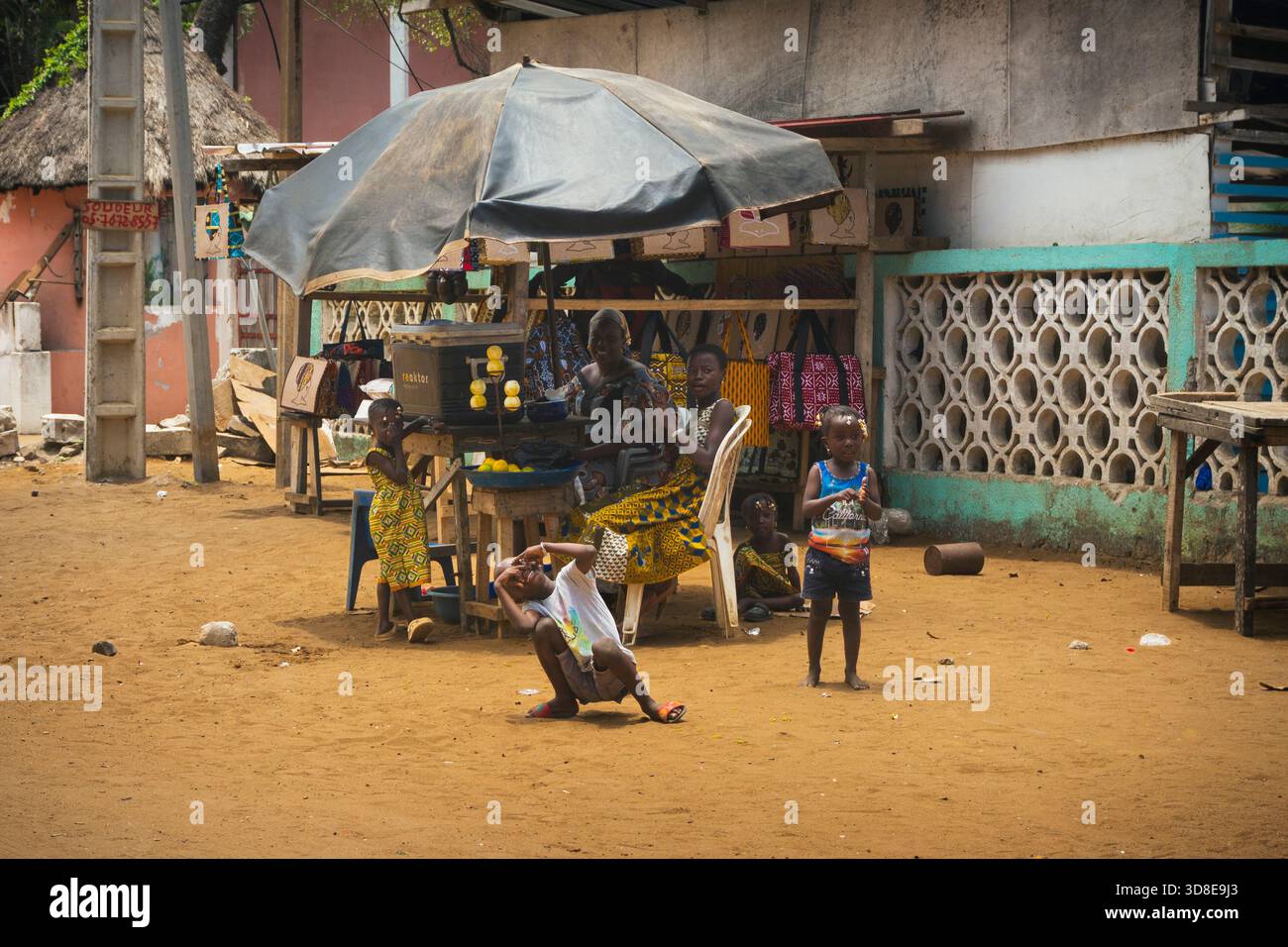 Happy kids having fun while mom is selling soda on the roads of Abidjan Stock Photo