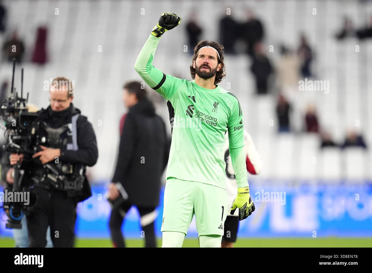Liverpool goalkeeper Alisson Becker acknowledges the fans following ...