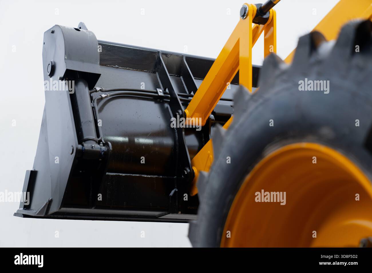 High-resolution image featuring the lifted bucket assembly of a ...