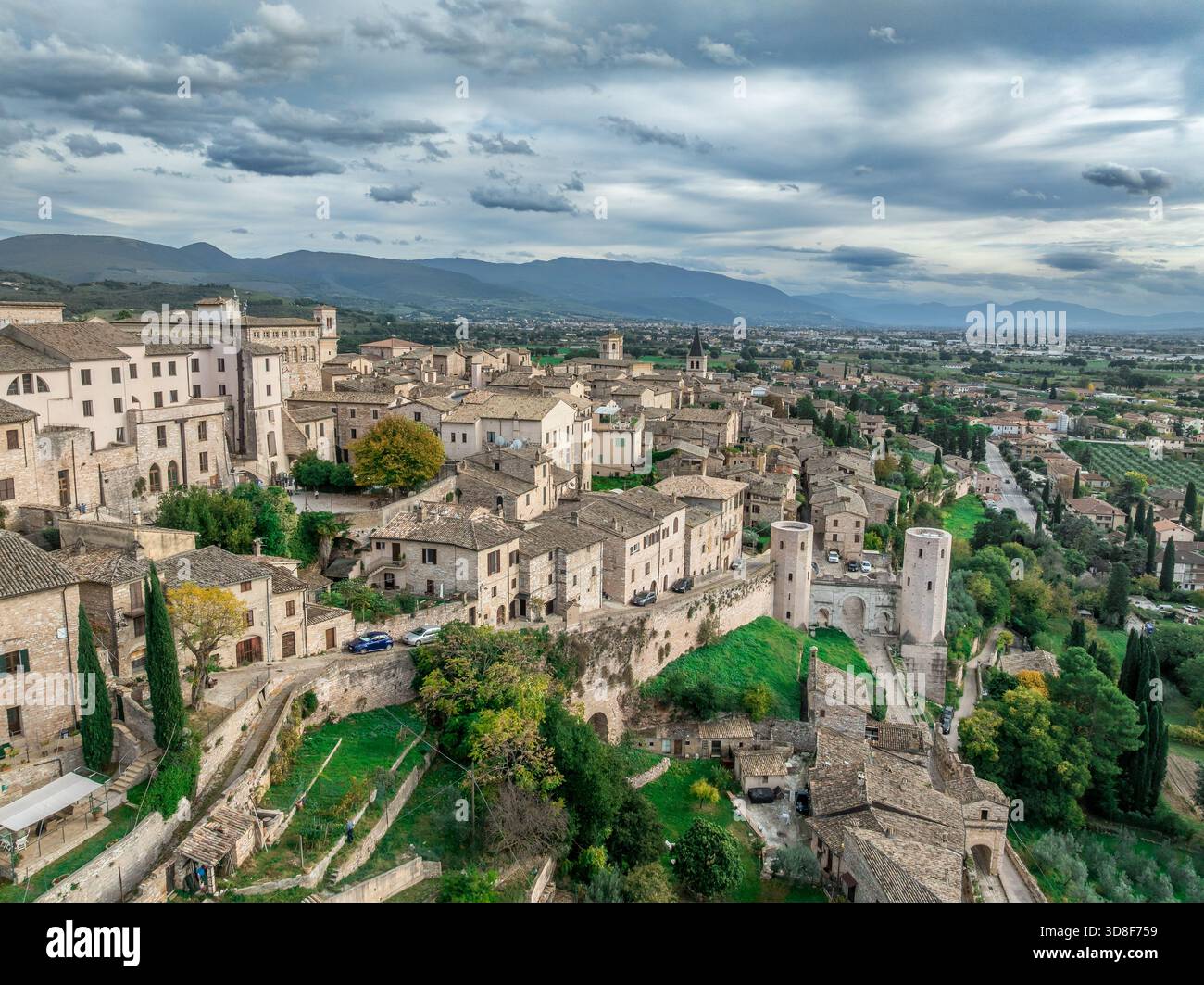 Aerial view of Spello enclosed in a circuit of medieval walls built on ...