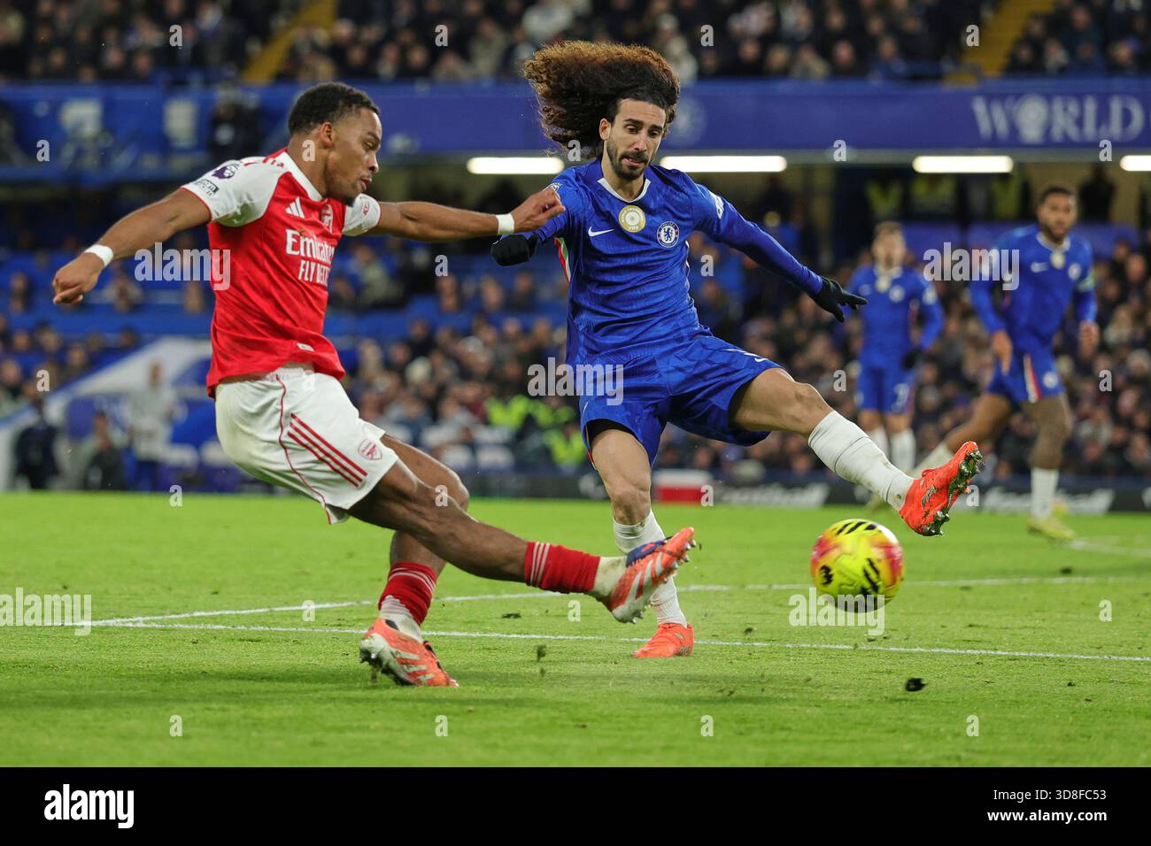 Arsenal's Jurrien Timber, left, kicks the ball ahead of Chelsea's Marc ...